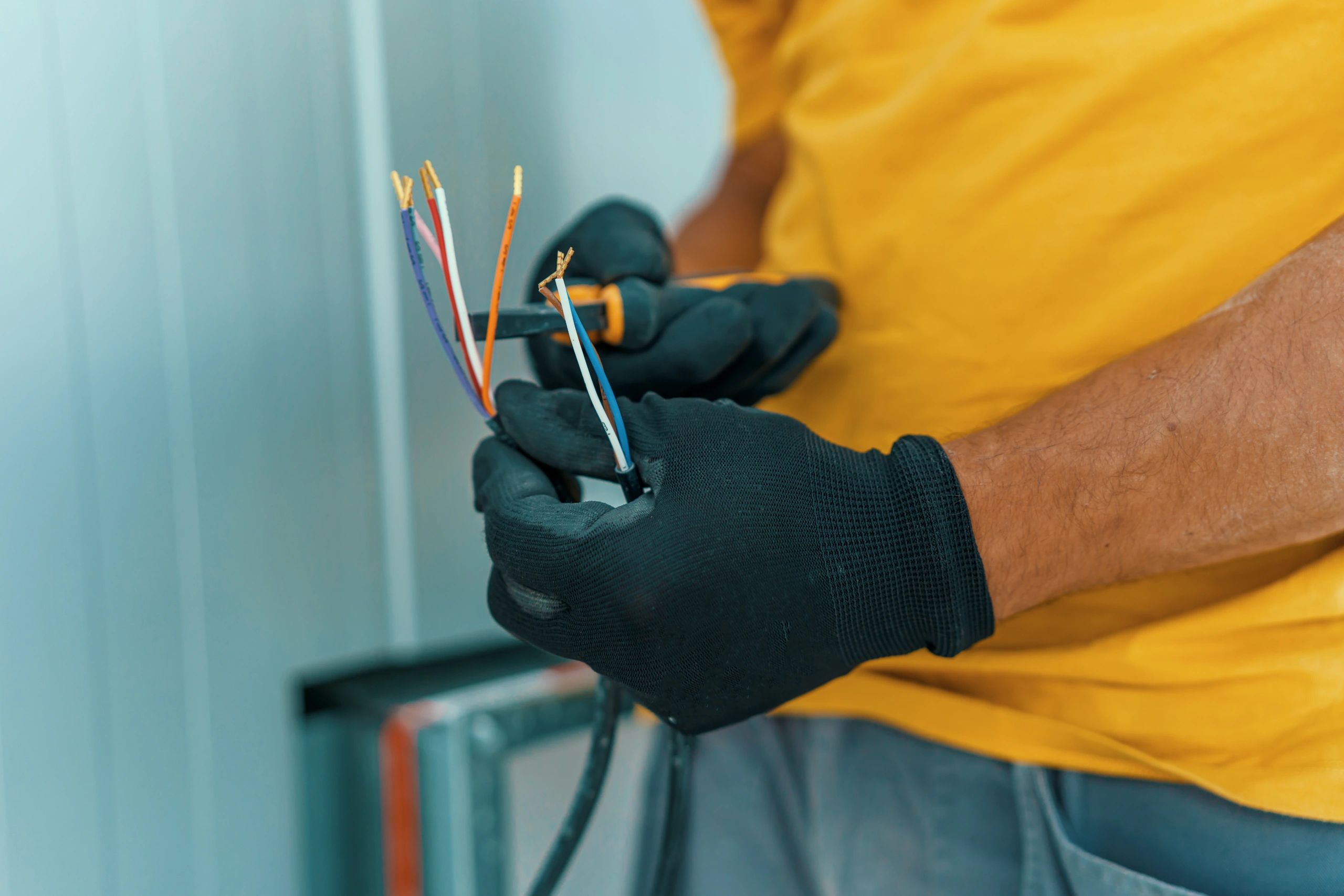 Technician holding wiring and tools