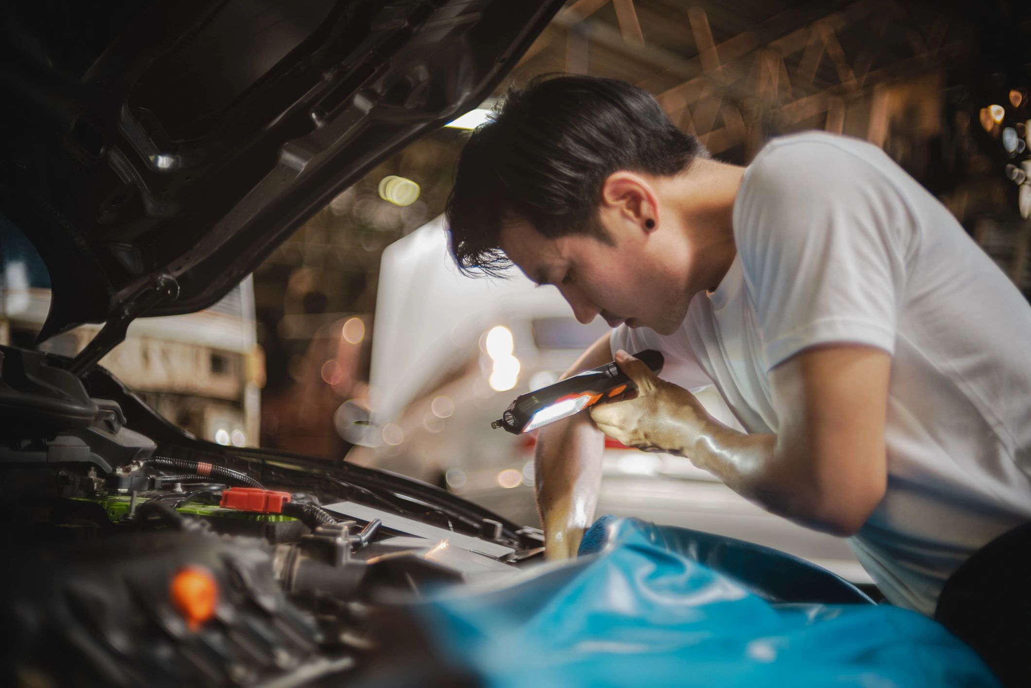 Technician examining an engine bay